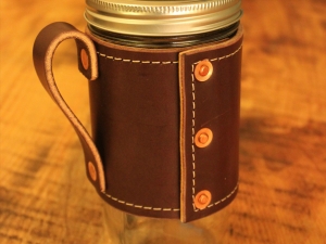 Holdster with rivets and handle on 24-ounce jar
